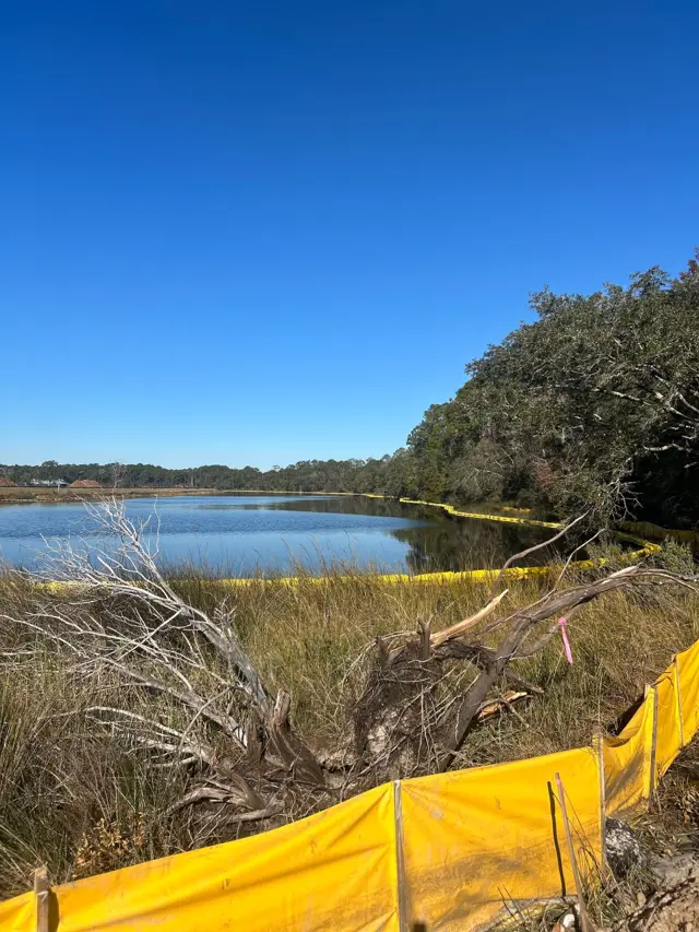 Floating turbidity barrier protecting a pond during construction